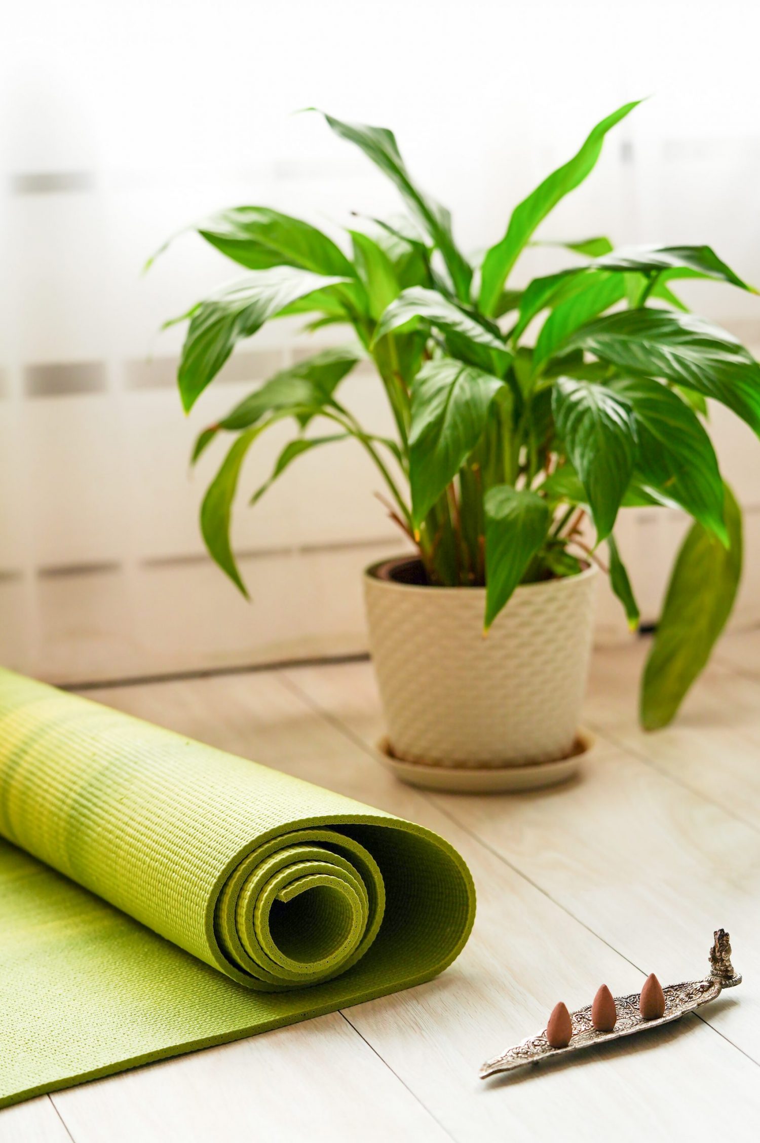 a place to practice yoga at home, a yoga mat and incense sticks, everything for meditation and relaxation.